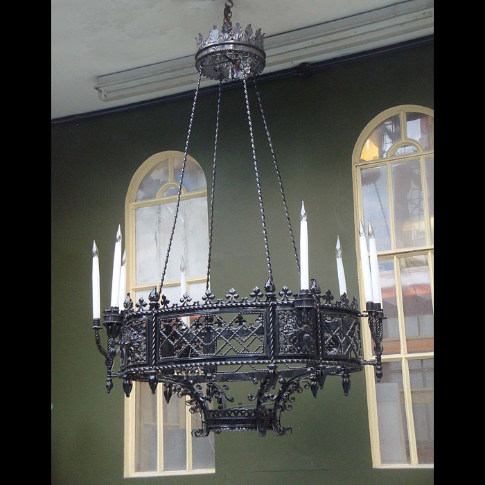Antique wrought iron chandelier 
 This large and ornate Neo-Gothic Chandelier has ten branches and is made from Wrought Iron. An upper floral crown has downward twisted ropes with a decorative lower Oval section. 

