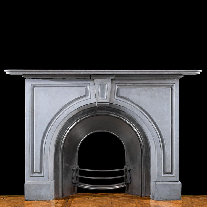 An arched limestone Victorian fireplace